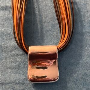 Minimalist Silver pendant on multiple cords.